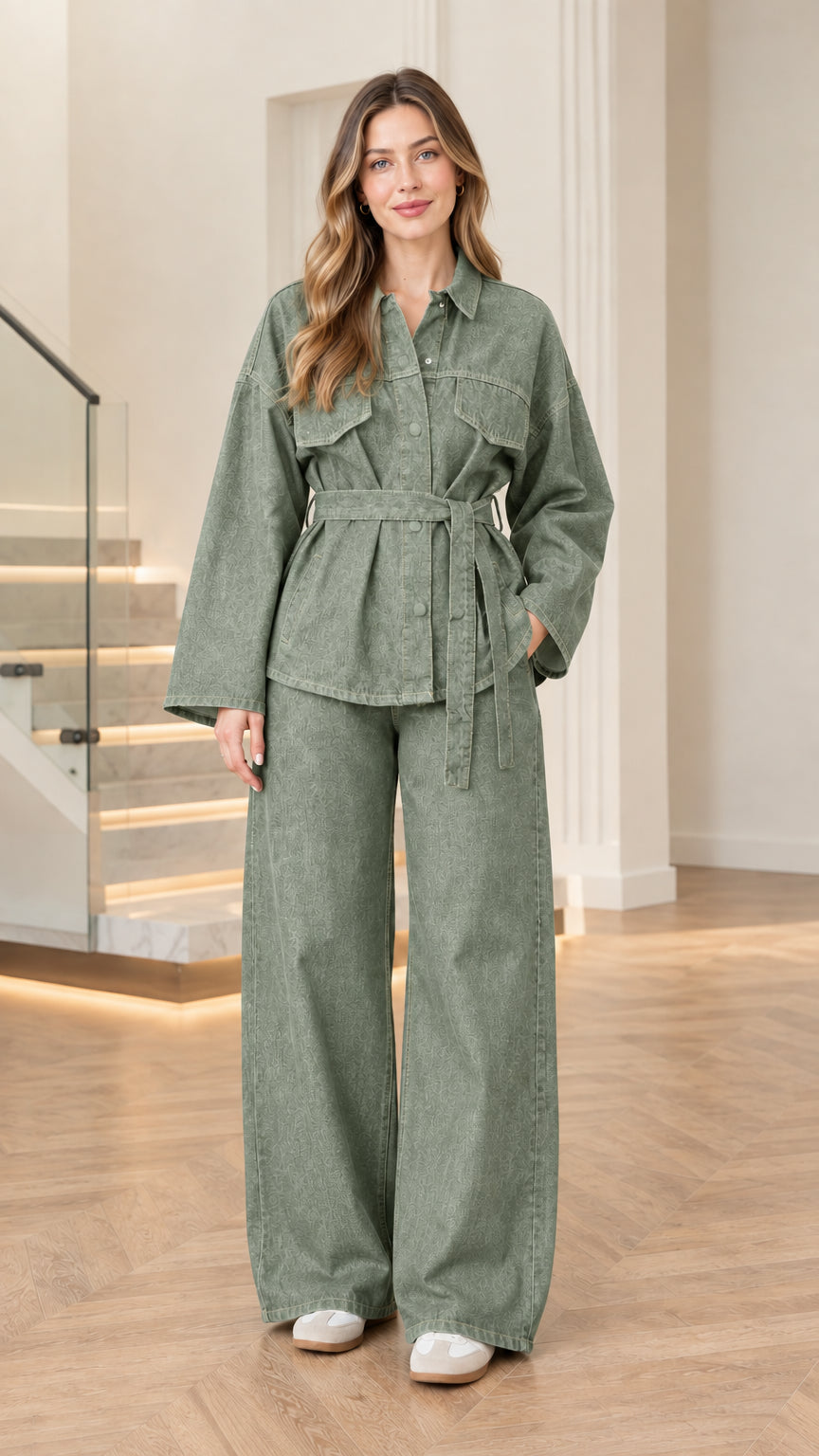 Model wearing sage green denim belted jacket and wide-leg pants set