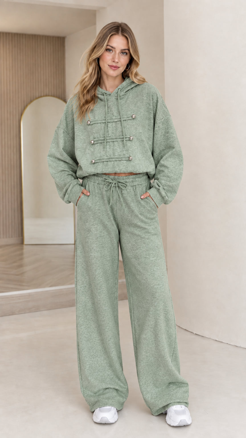 Full-body view of model wearing sage green cropped hoodie and wide leg lounge set