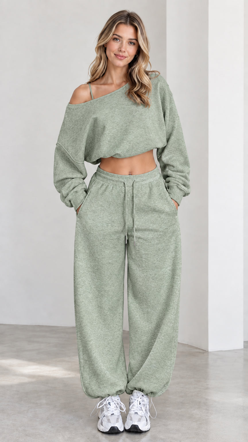 Model wearing sage green two-piece cropped top and baggy sweatpants set