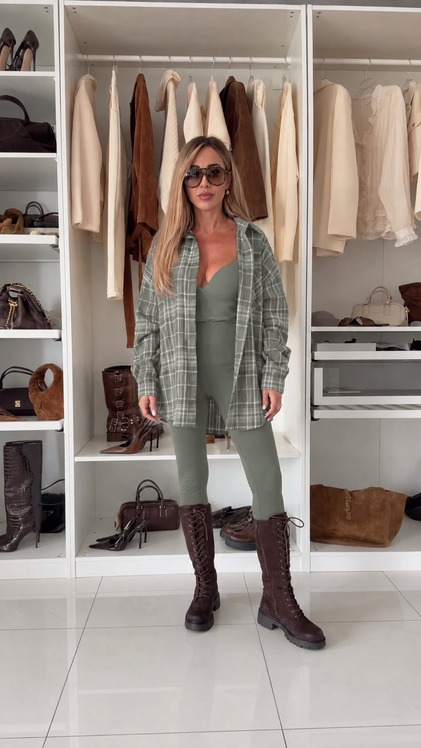 Woman wearing sage green plaid button-up shirt over matching jumpsuit