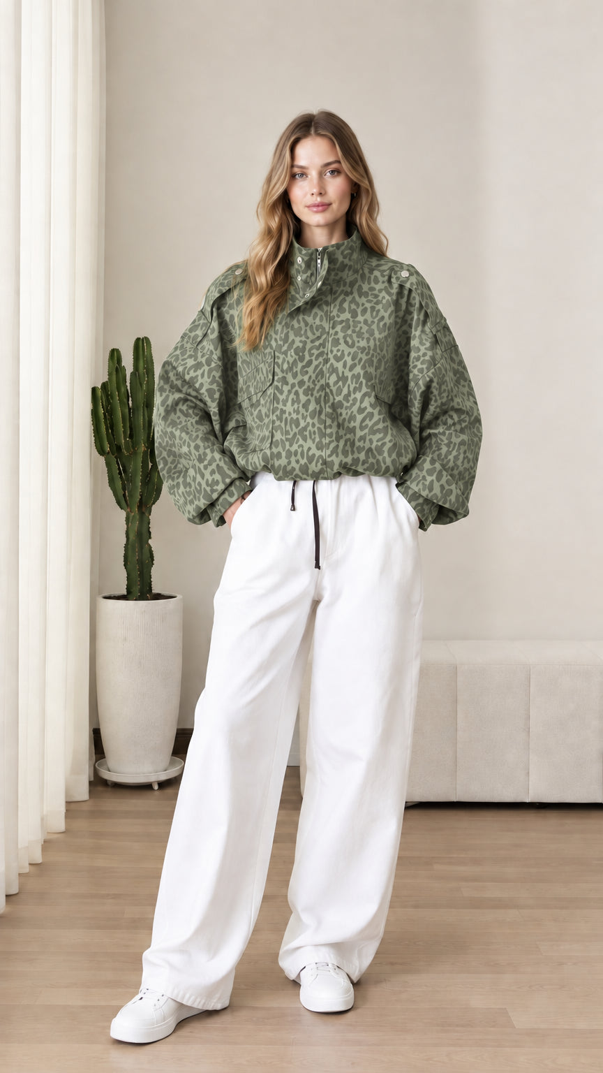 Front view of model wearing sage green leopard print half-zip anorak jacket
