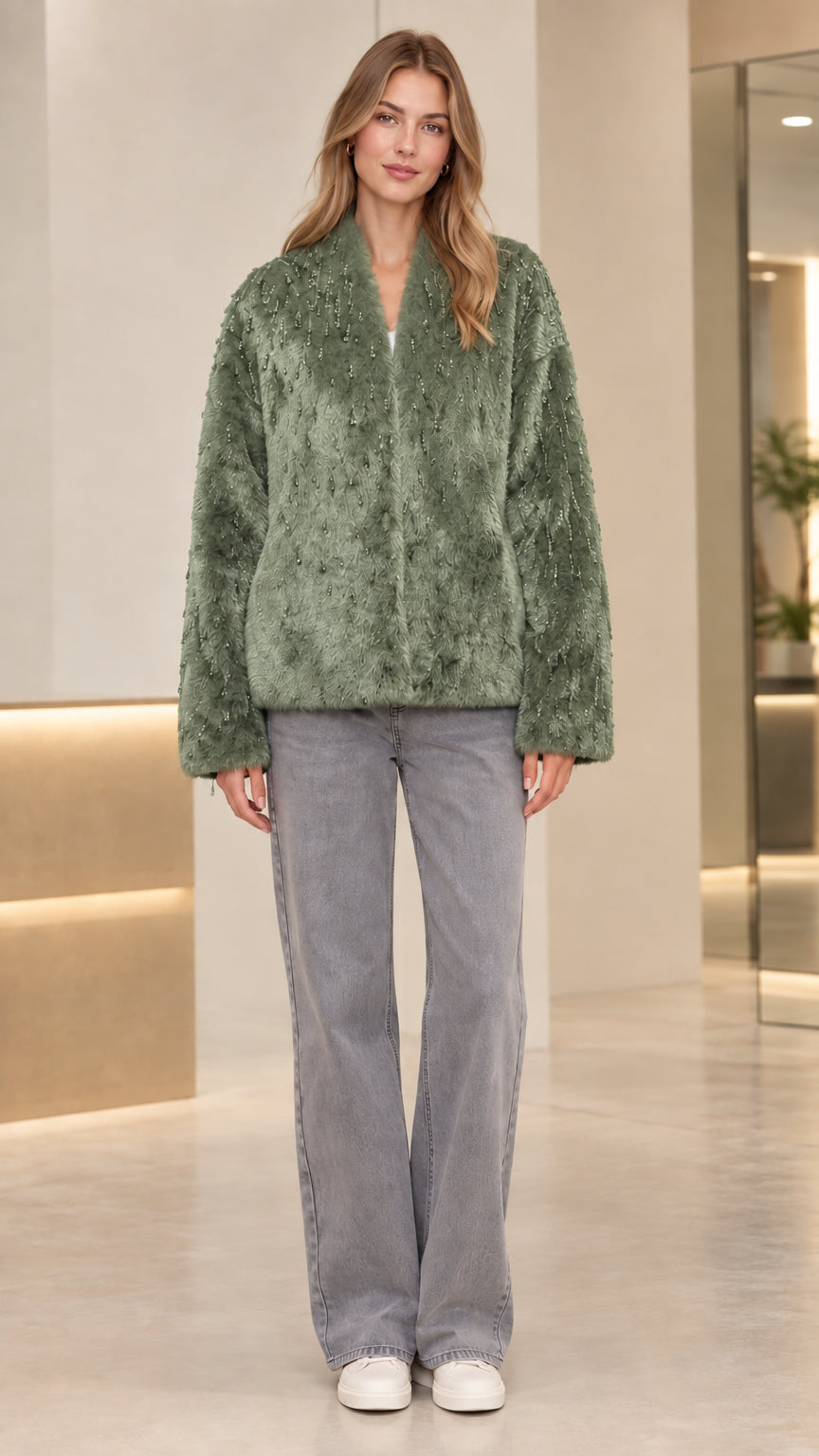 Front view of model wearing sage green beaded faux fur jacket