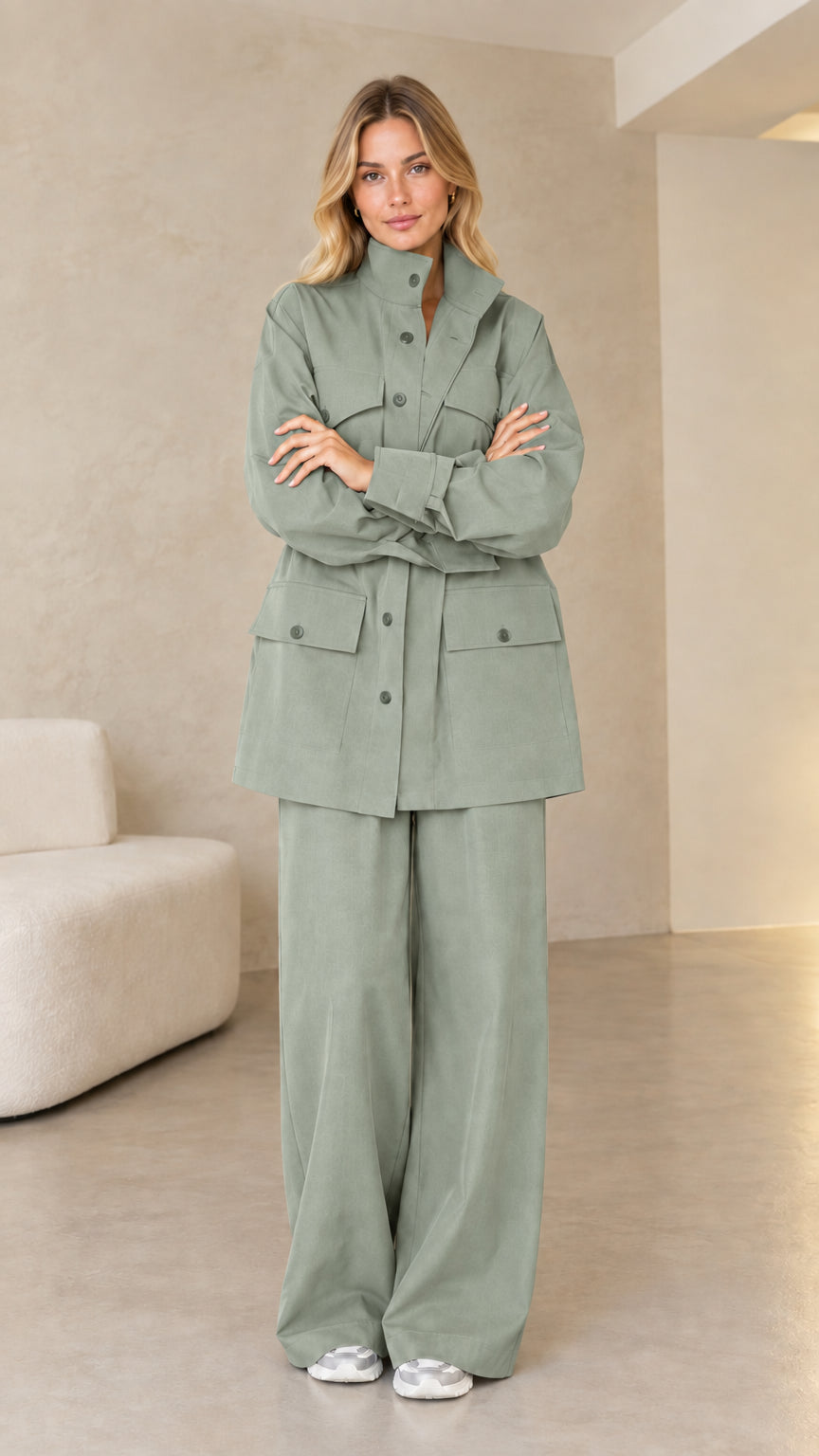 Model wearing muted sage green utility jacket and wide-leg pants set