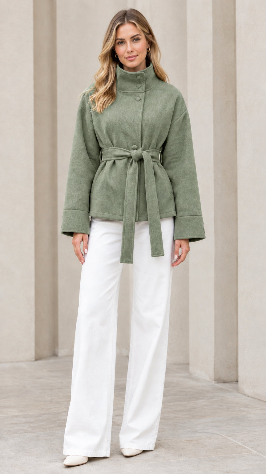Front view of model wearing sage green stand collar belted short coat