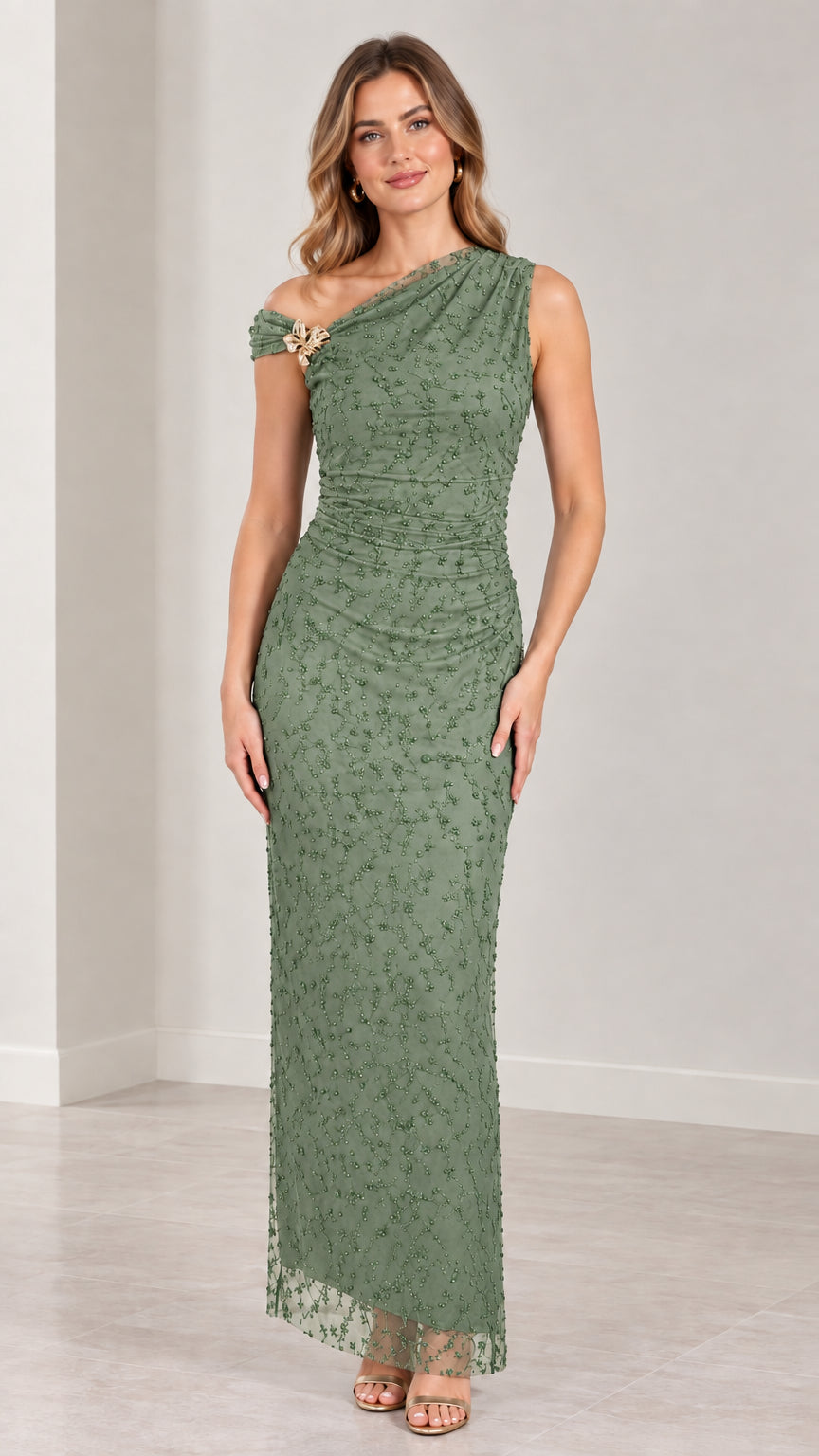 Full-length view of sage green one-shoulder formal dress with brooch detail