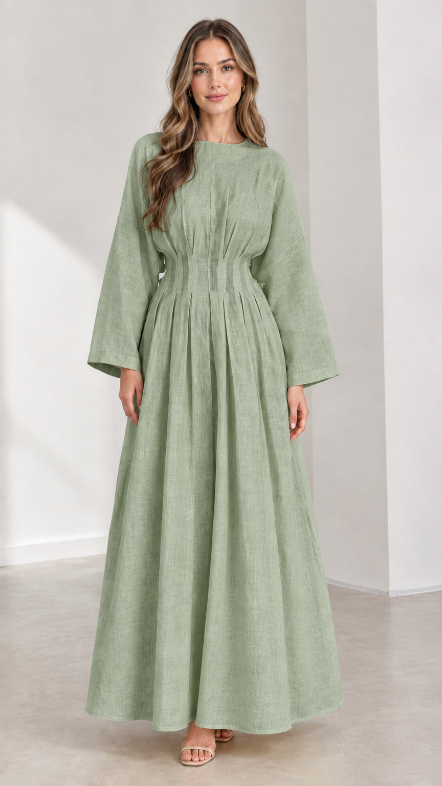 Front view of woman wearing Sage Green pleated waist long sleeve maxi dress
