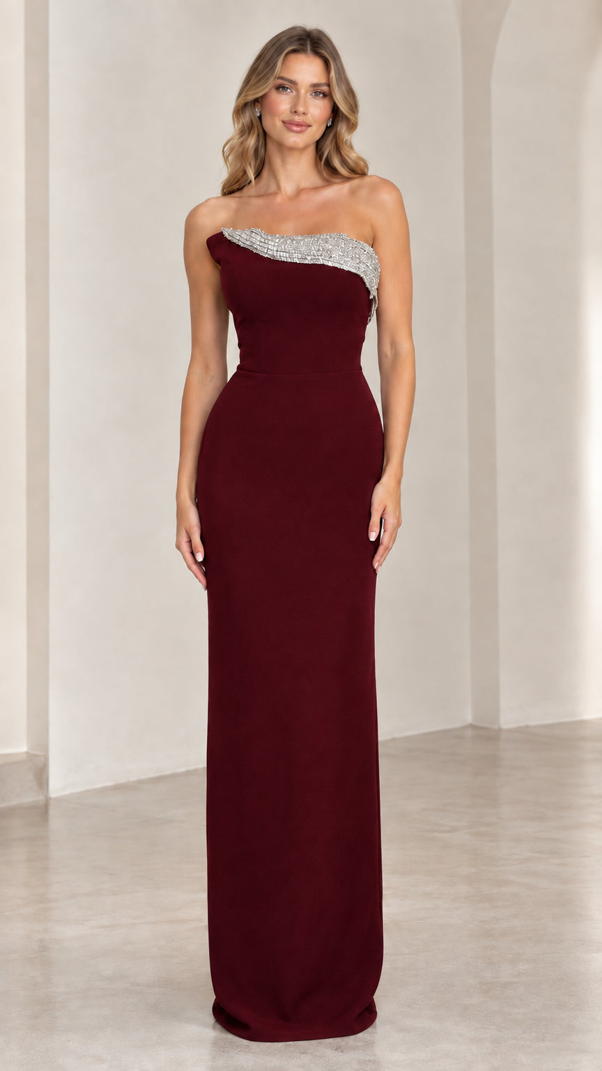Front view of burgundy red strapless formal evening dress with rhinestone detailing