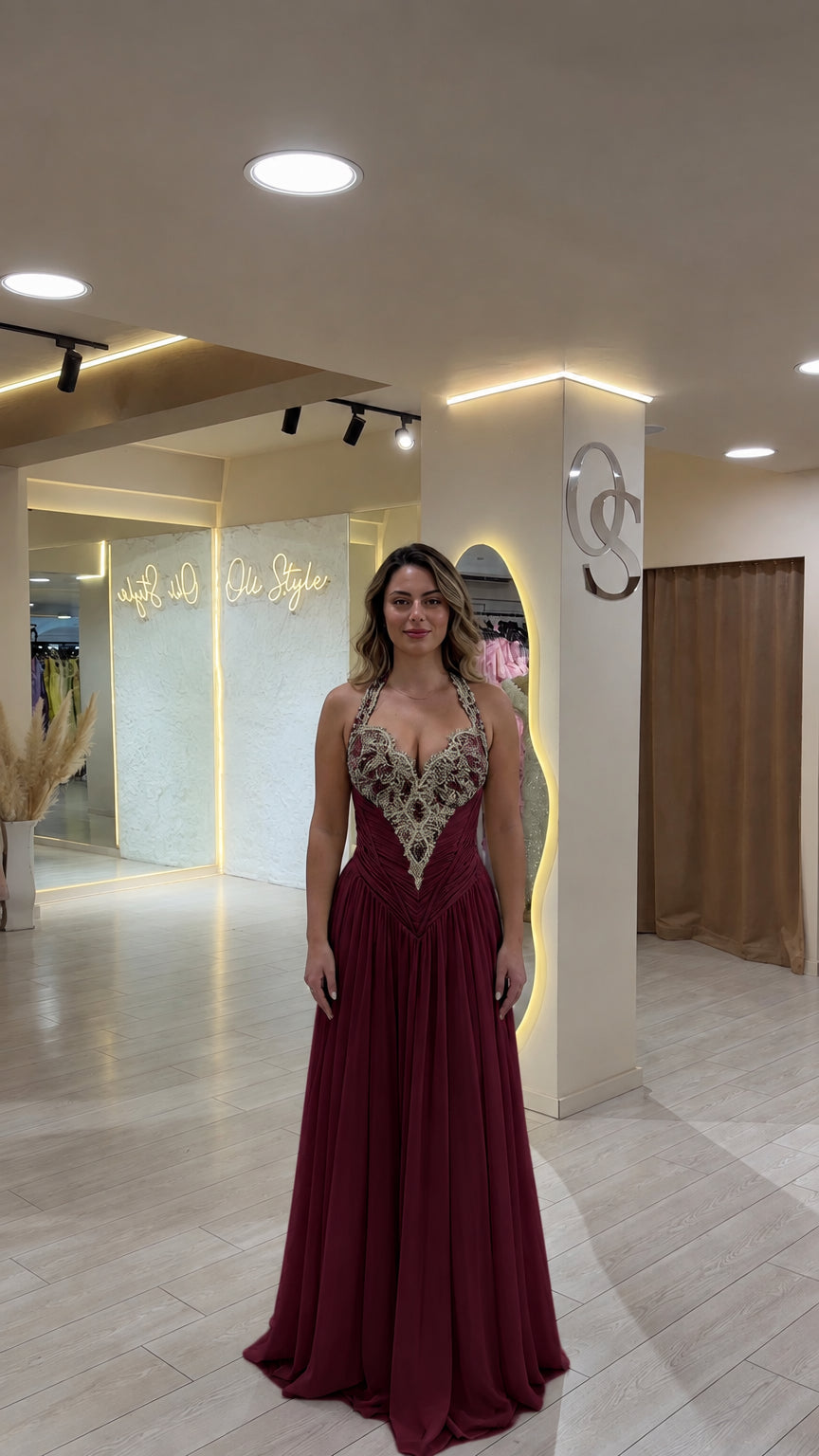 Model wearing deep burgundy red beaded halter formal maxi dress