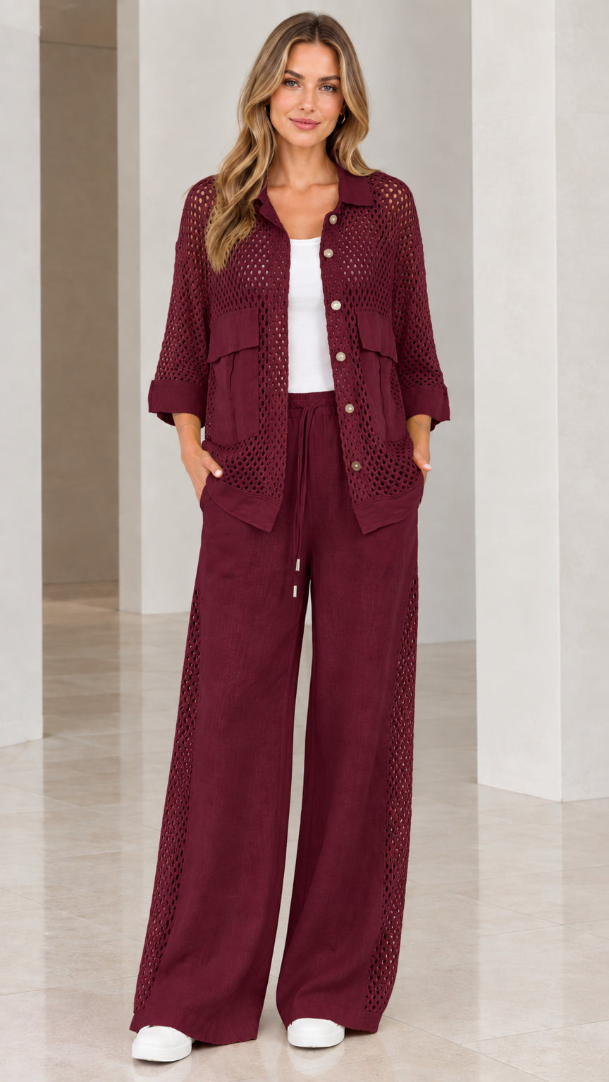 Full front view of woman wearing burgundy wine open knit shirt and pants set