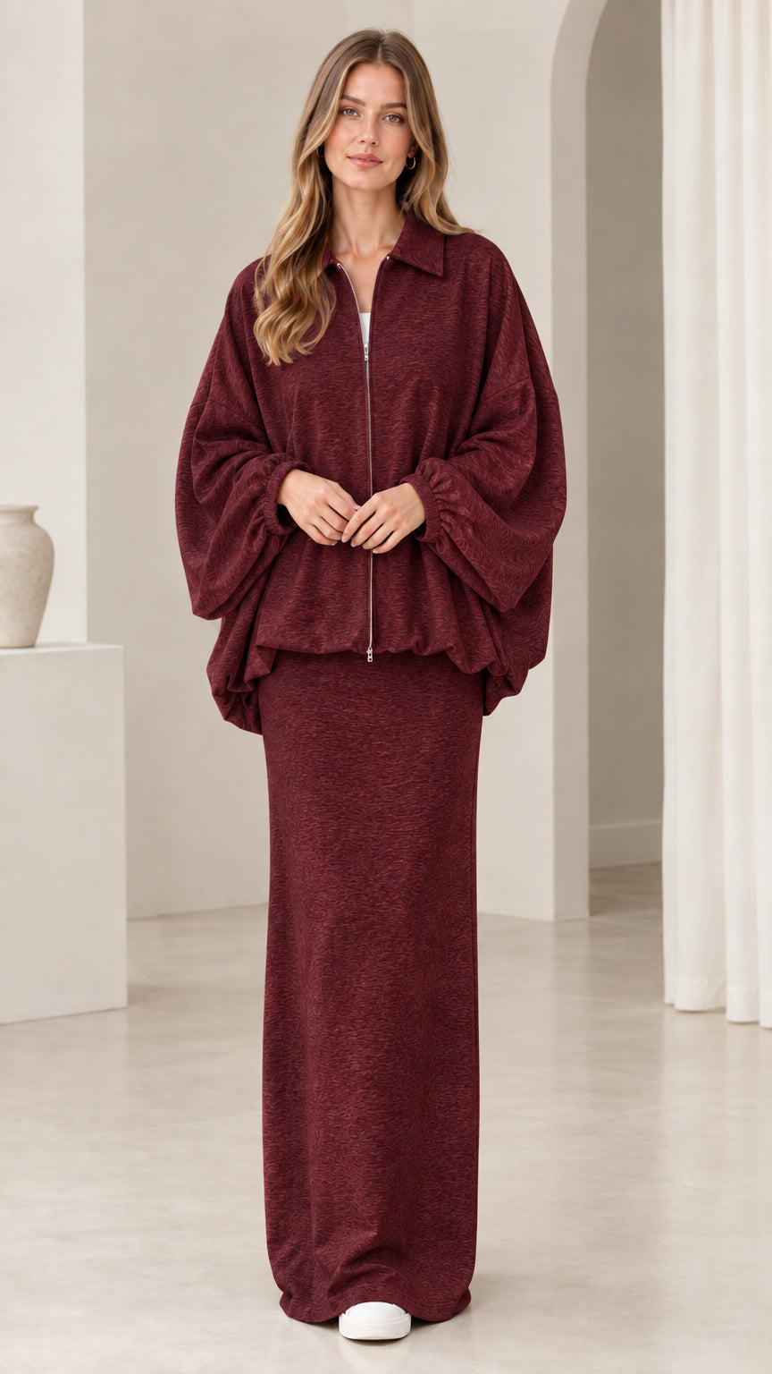 Model wearing burgundy wine red zip-front jacket and maxi skirt set