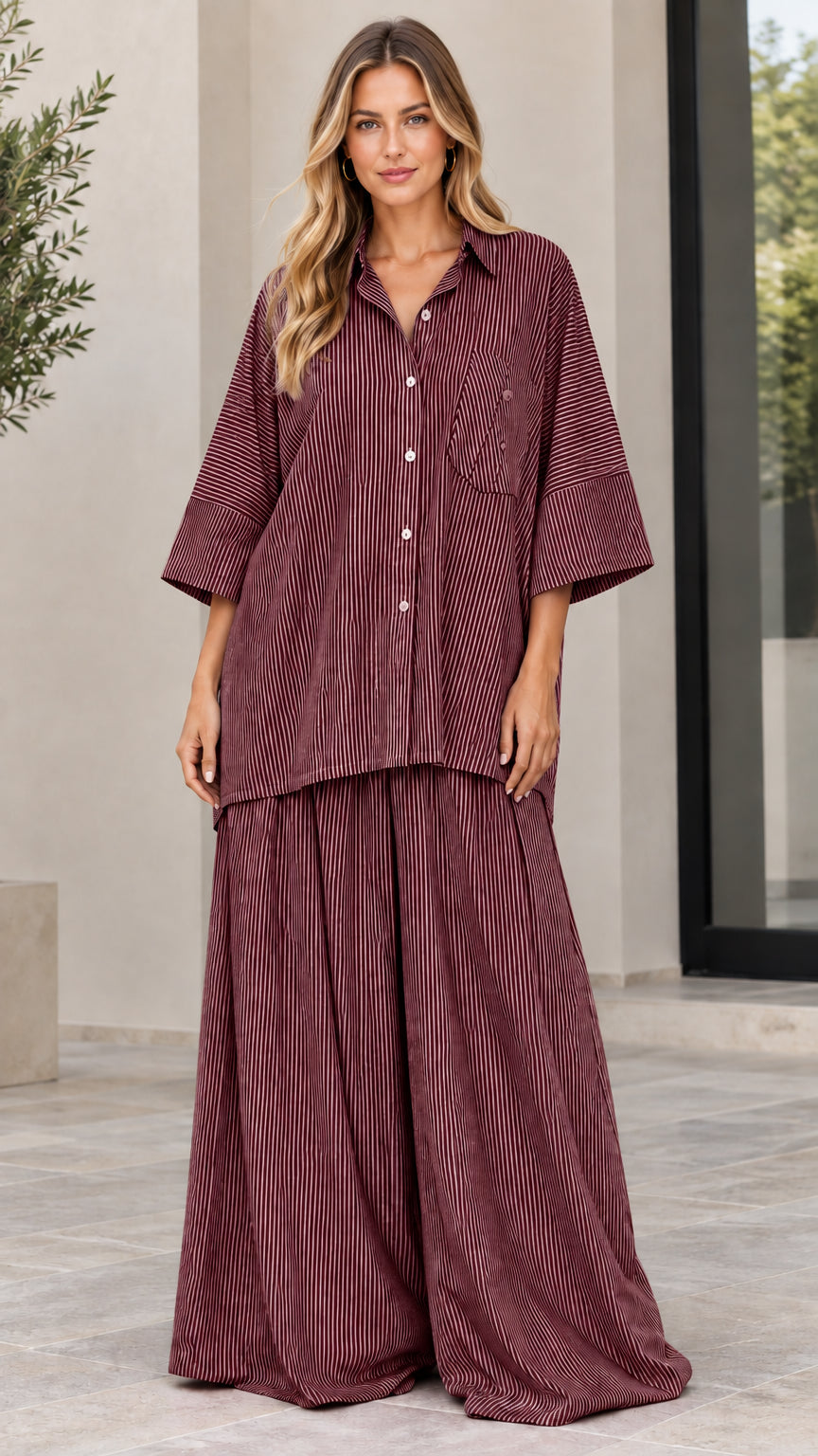 Woman wearing burgundy red striped oversized button-up and wide-leg pants set