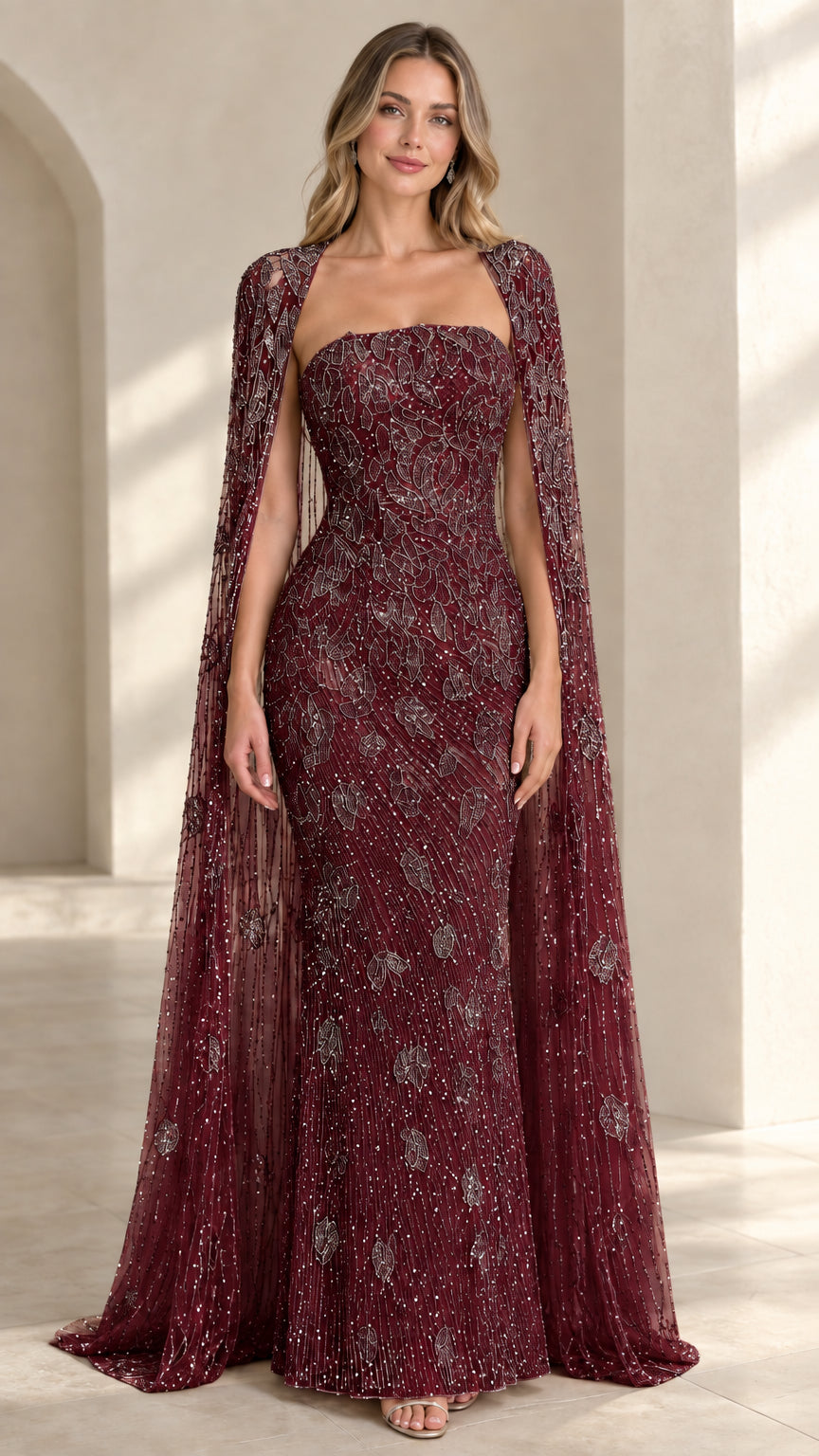 Front view of burgundy wine beaded strapless formal evening dress with cape