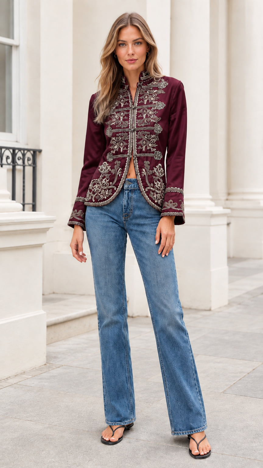 Model wearing rich burgundy embroidered stand collar jacket with denim jeans