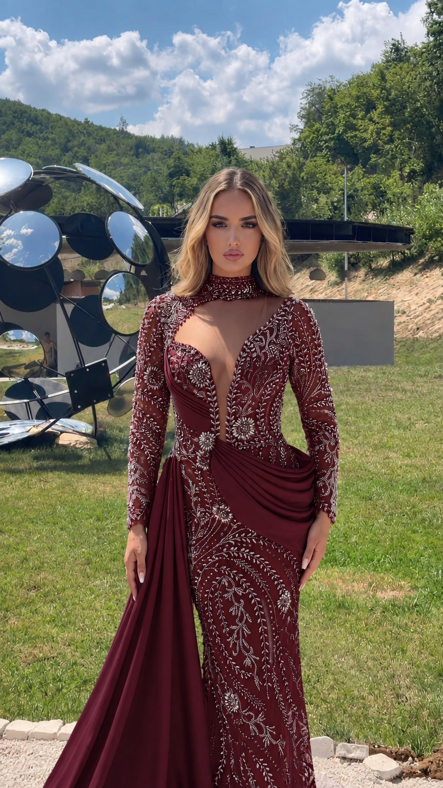 Model wearing burgundy red beaded long sleeve gown with side sash