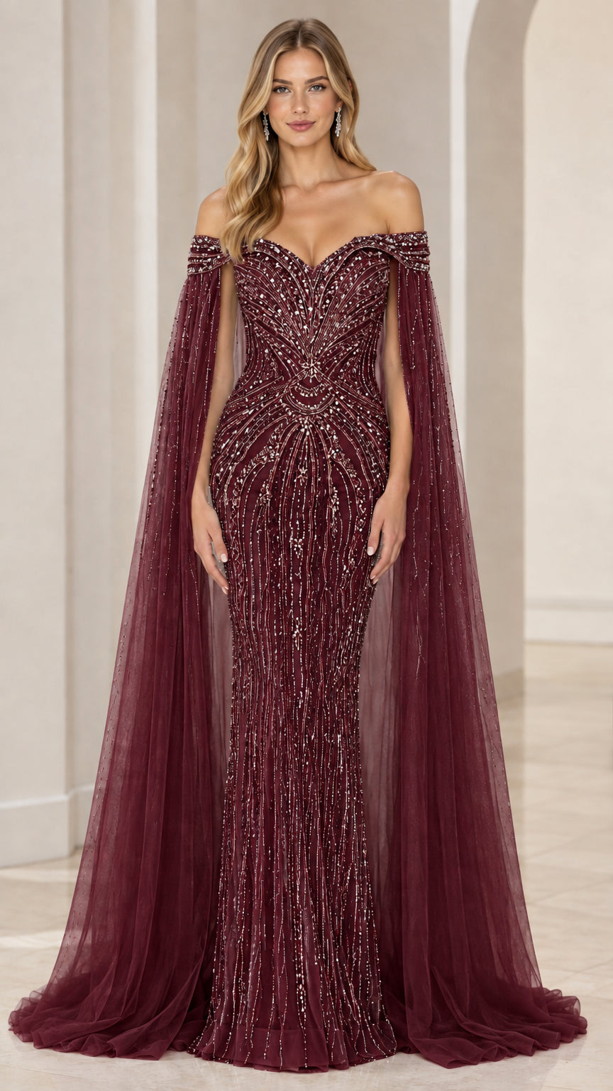 Front view of deep burgundy wine beaded sweetheart gown with dramatic cape