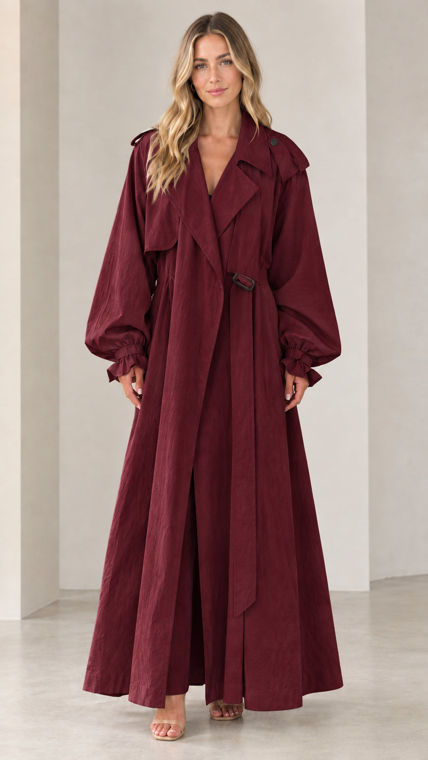 Front view of woman wearing full-length burgundy wine belted maxi trench coat