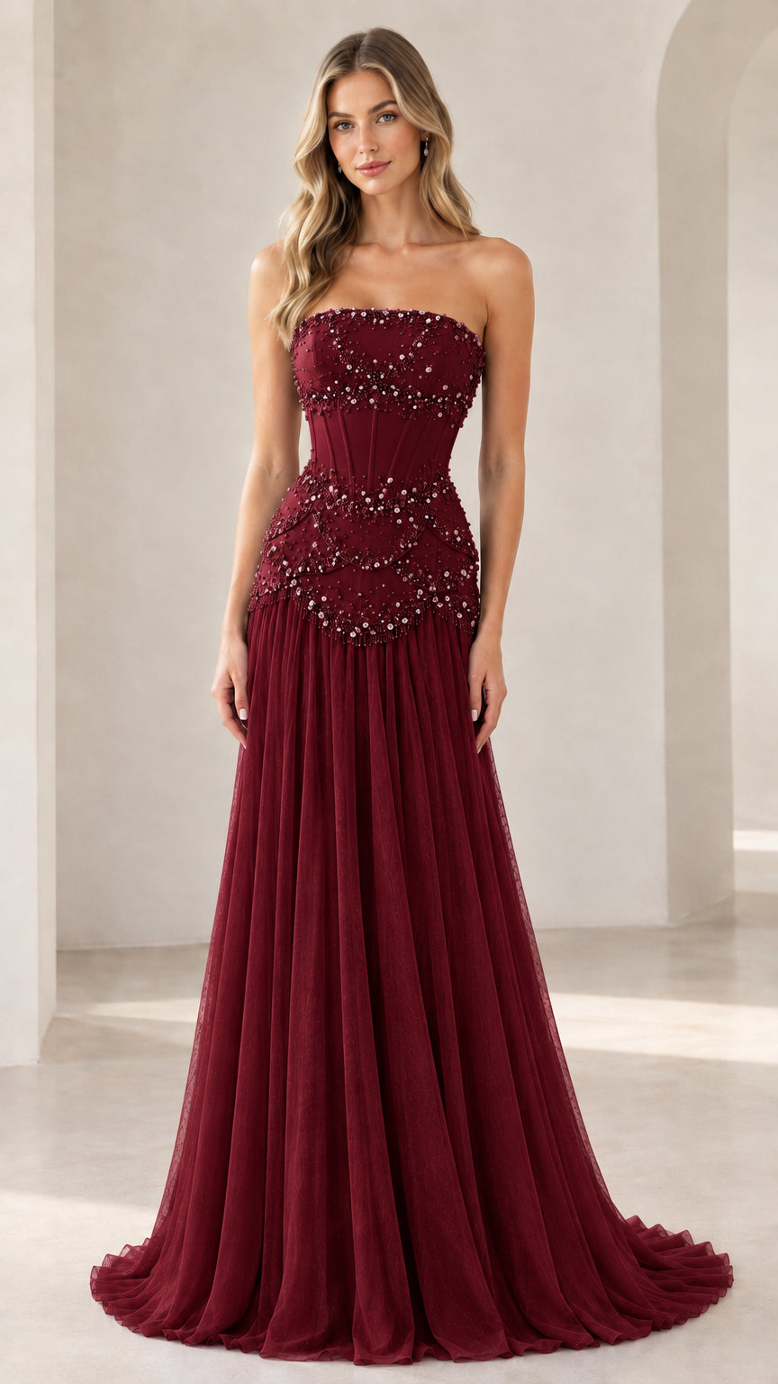 Model wearing burgundy red strapless pearl embellished formal gown