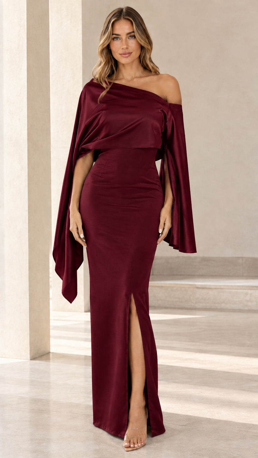 Model wearing burgundy wine red cape sleeve satin formal evening gown