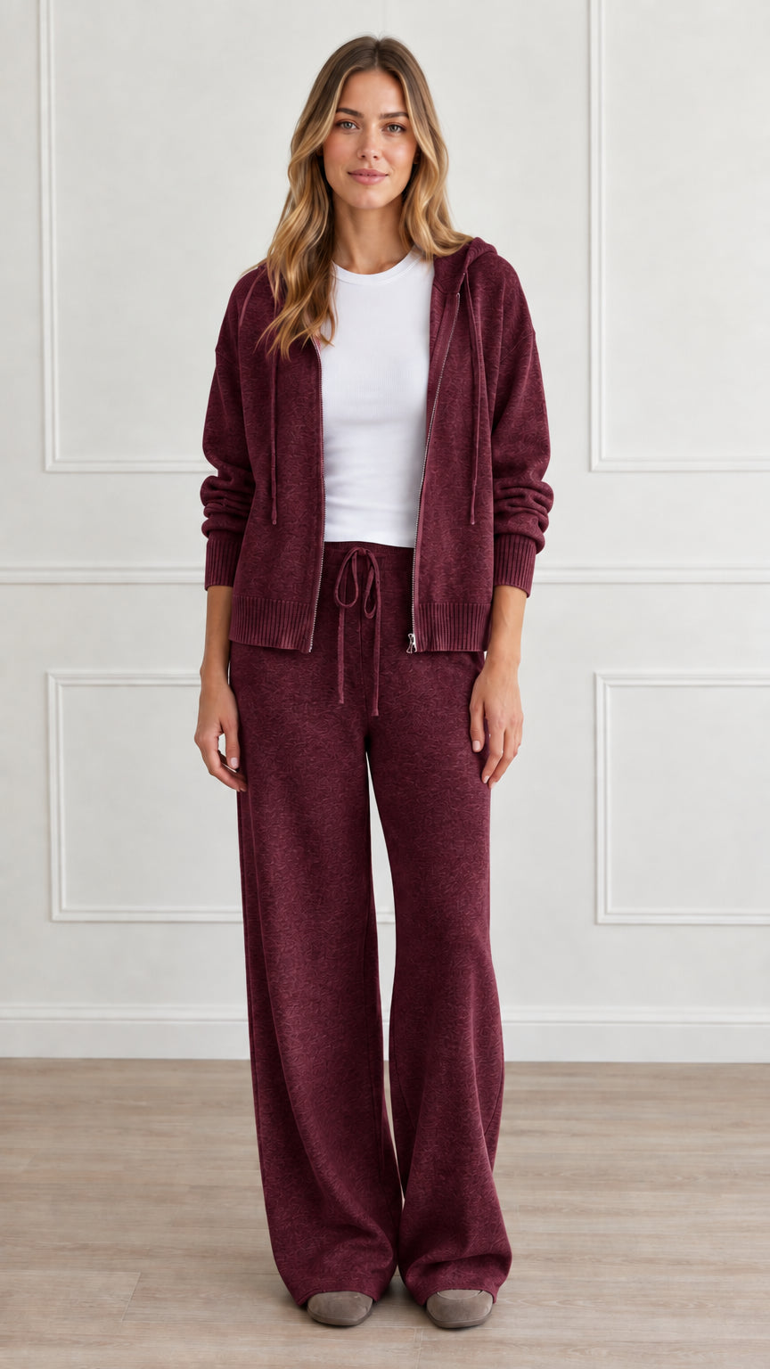 Front view of model wearing burgundy knit zip hoodie and wide-leg pants set