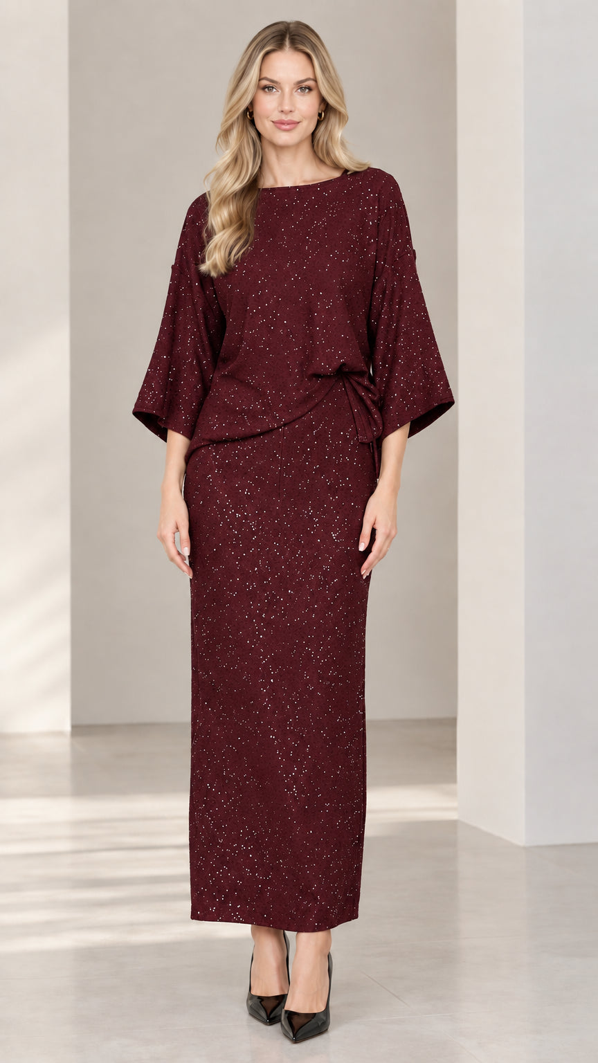 Full-length studio shot of woman wearing burgundy wine sparkle boat neck two-piece set