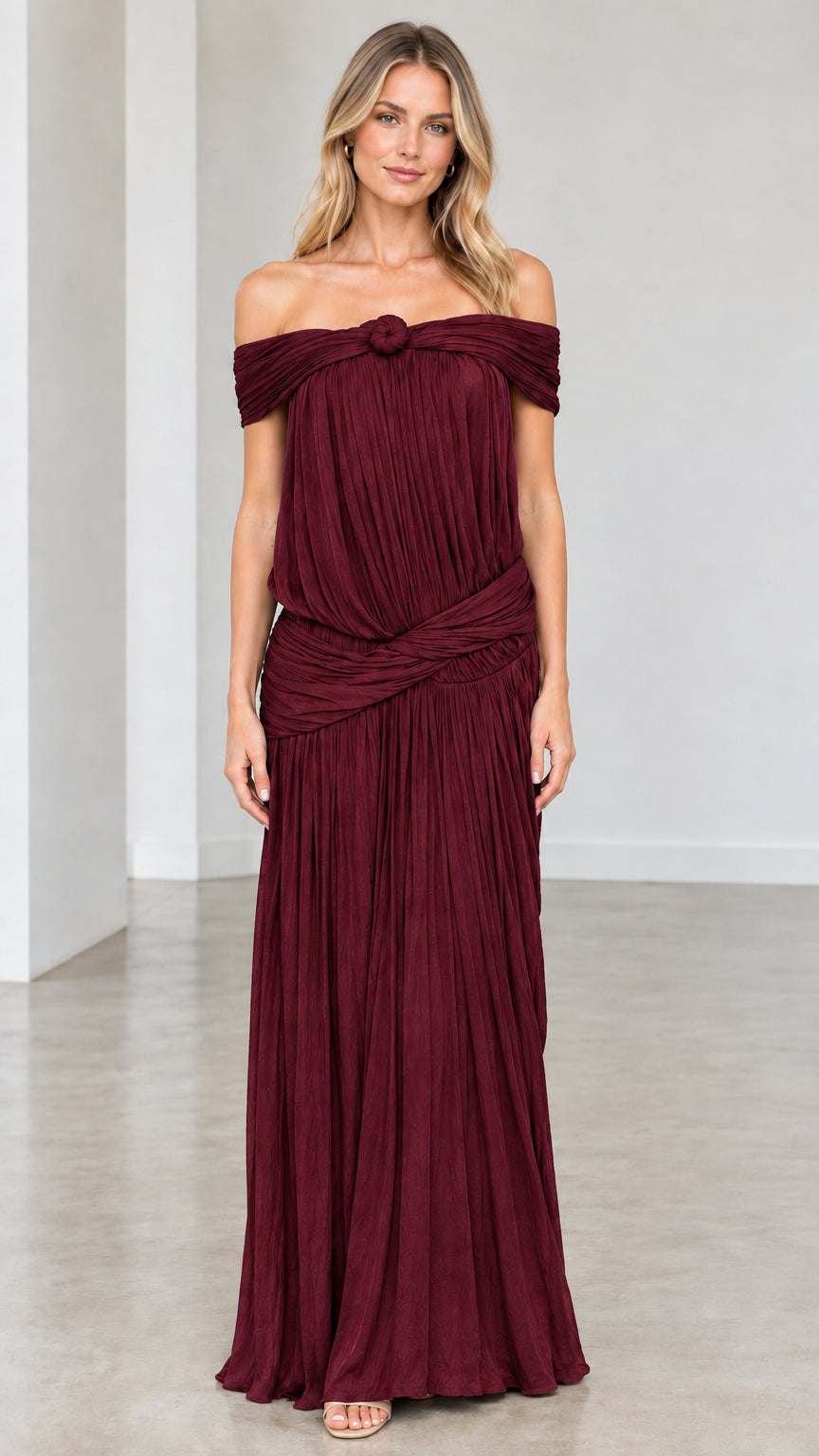 Full-length front view of model wearing Burgundy pleated evening gown