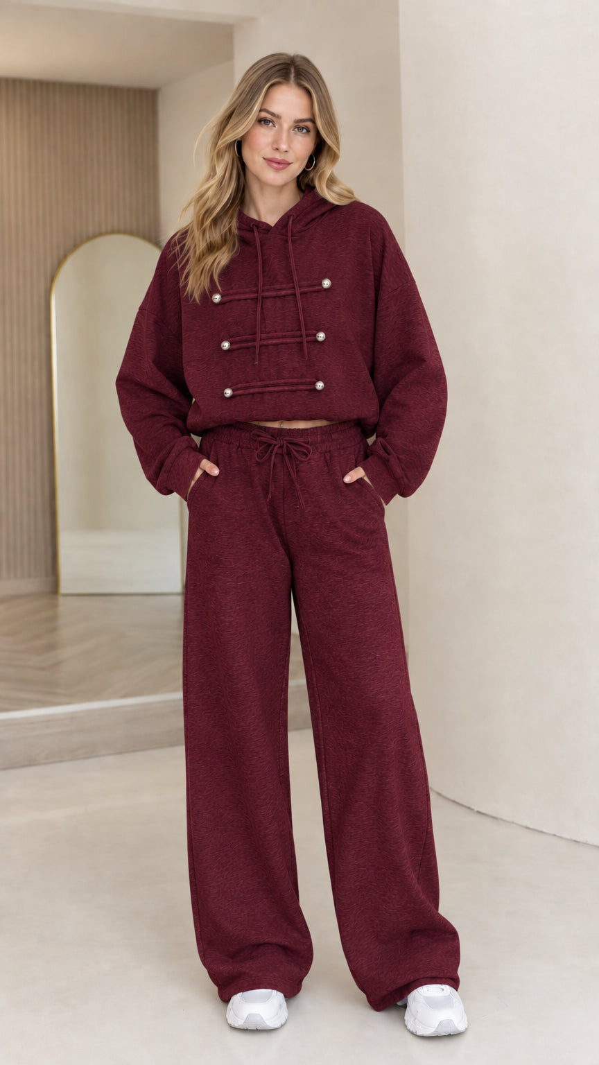 Full-body view of model wearing burgundy wine cropped hoodie and wide leg lounge set