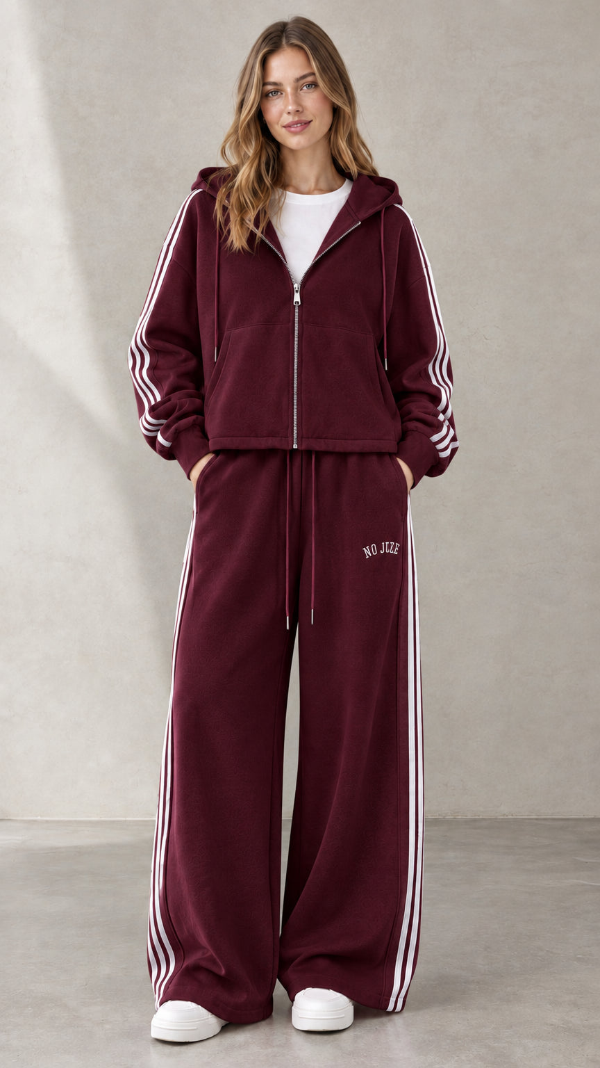 Woman wearing Burgundy two-piece hooded sweatshirt and wide-leg pants set