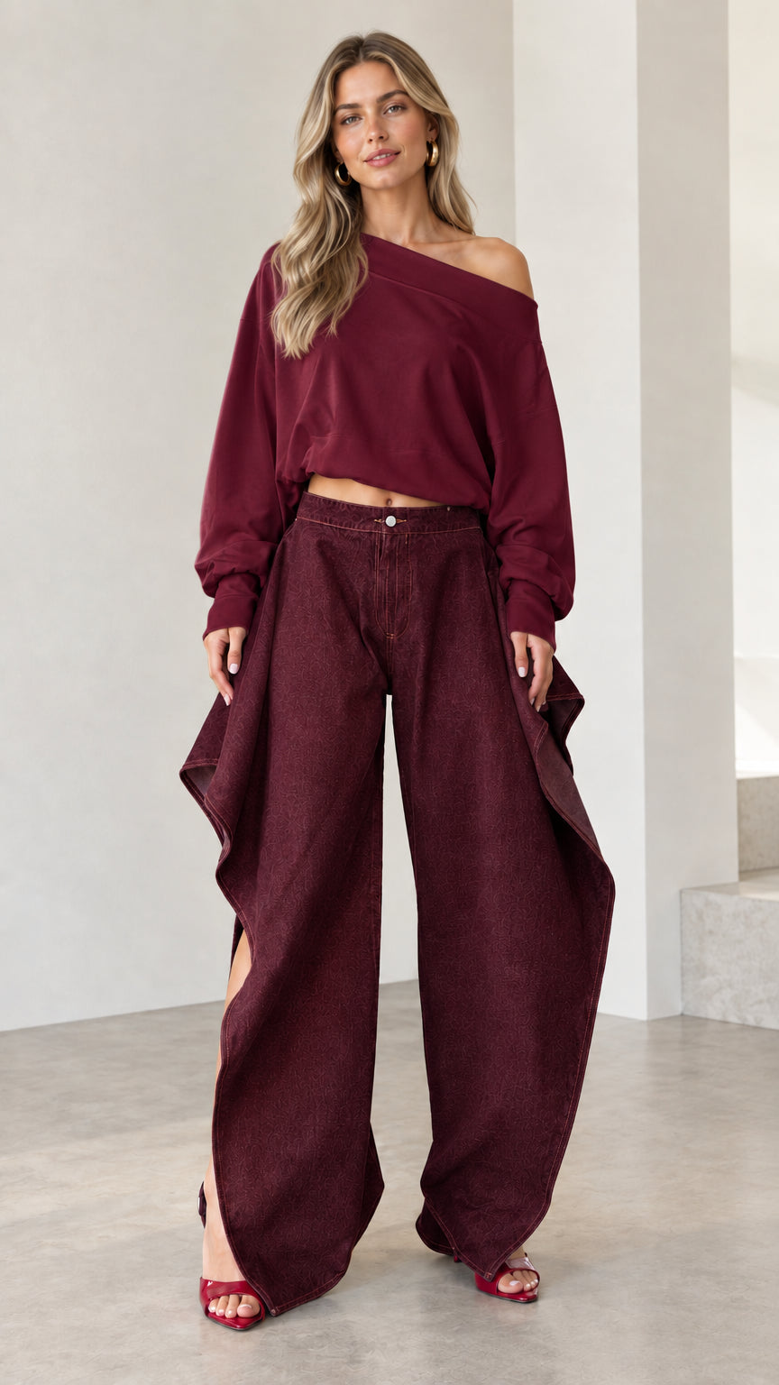Full front view of burgundy monochromatic set featuring burgundy draped wide-leg denim pants