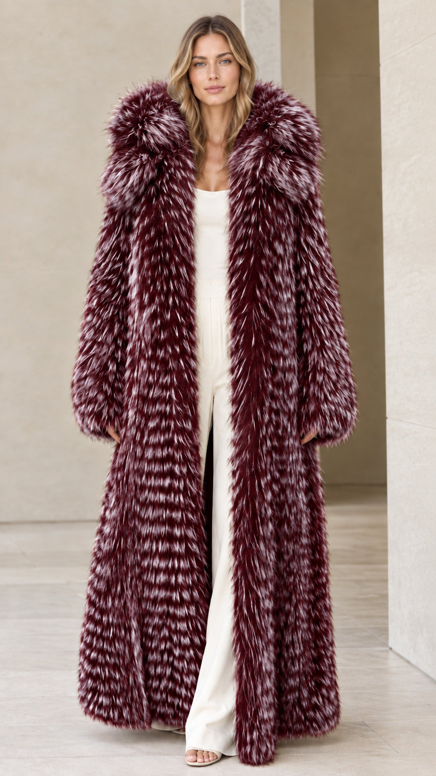 Front view of woman wearing burgundy wine full-length hooded faux fur coat