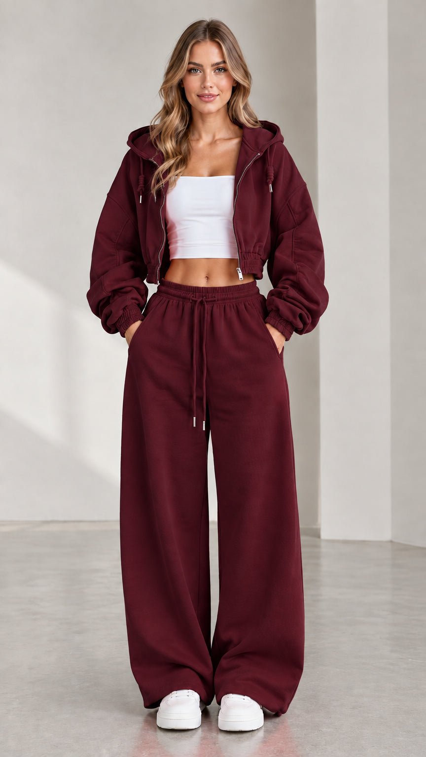 Woman wearing burgundy wine red cropped zip-up hoodie and matching baggy sweatpants