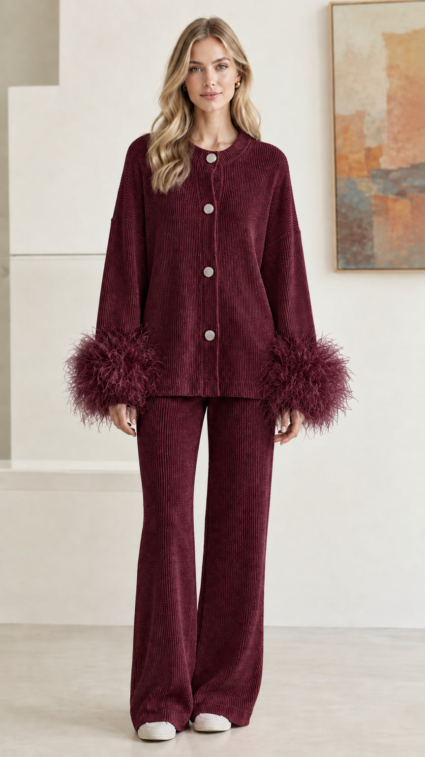 Front view of model wearing rich burgundy wine ribbed knit two-piece set with feather cuffs