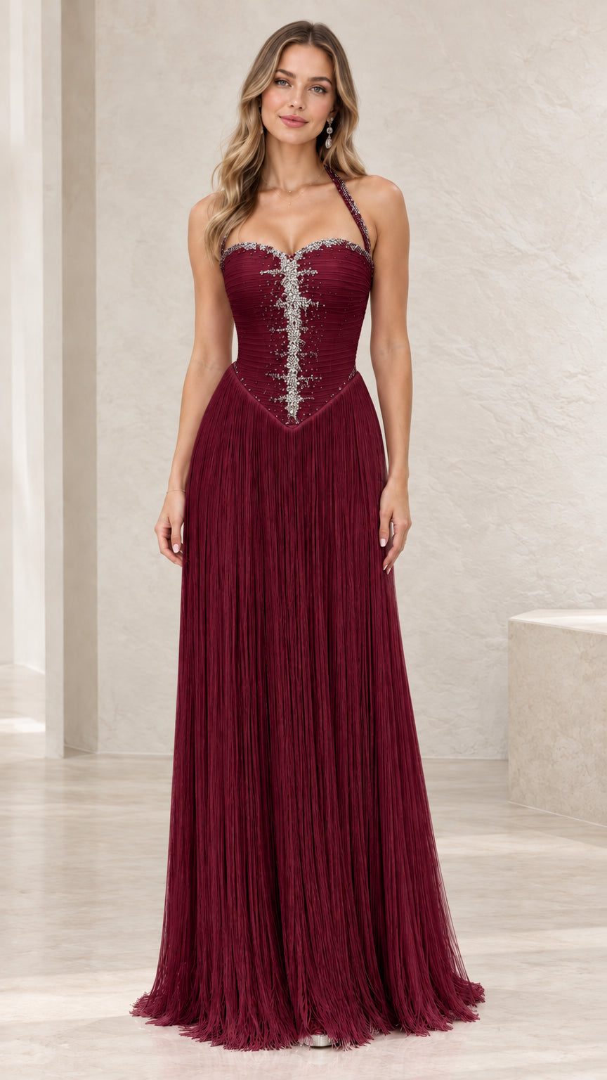 Full-length view of burgundy rhinestone halter fringe evening gown