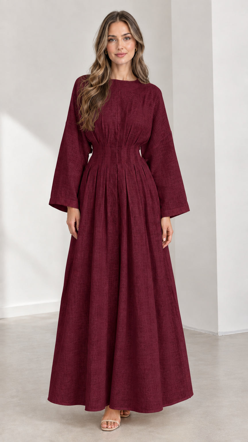 Front view of woman wearing Burgundy long sleeve pleated waist maxi dress