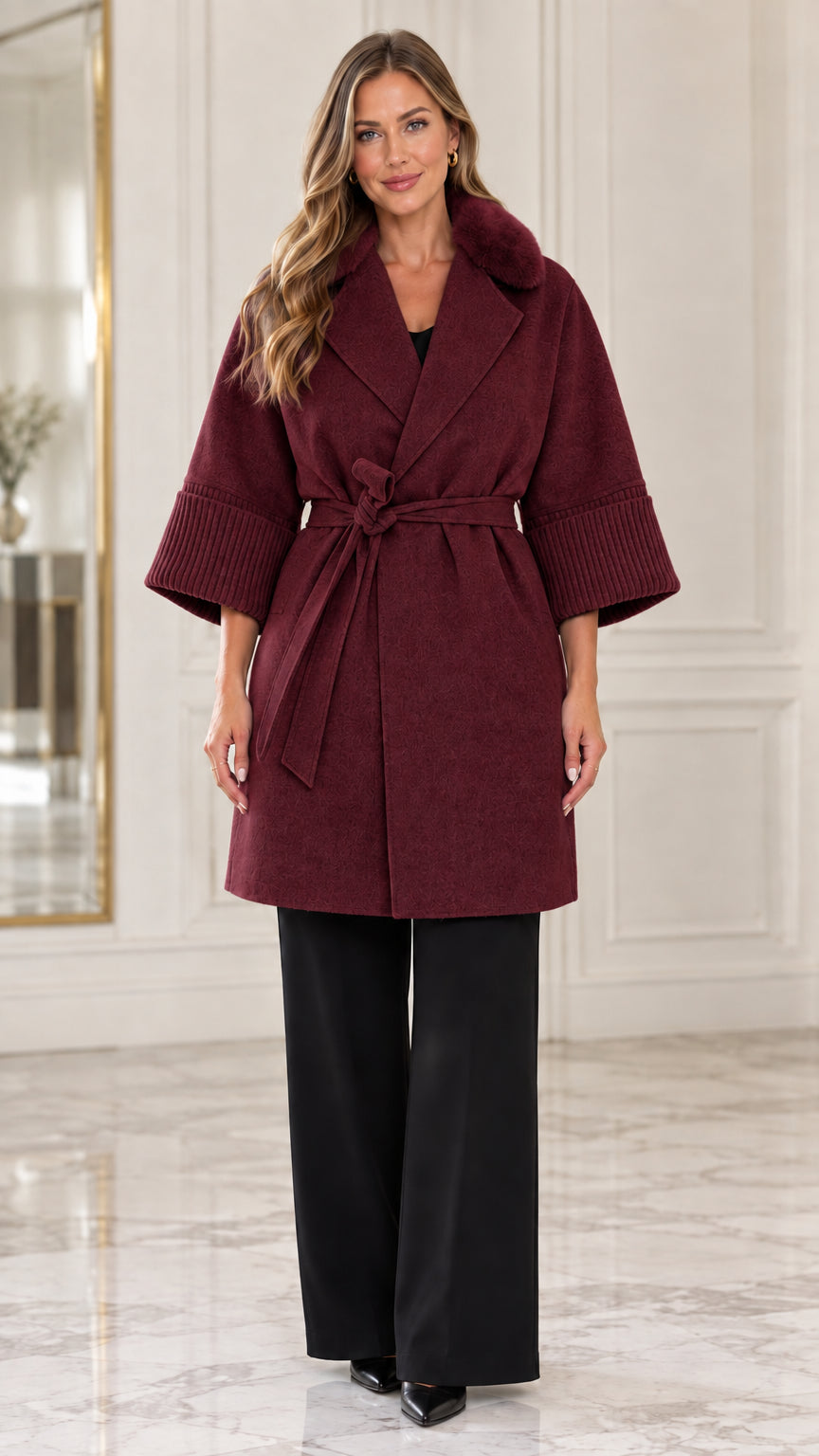 Front view of model wearing the burgundy faux fur collar belted wrap coat