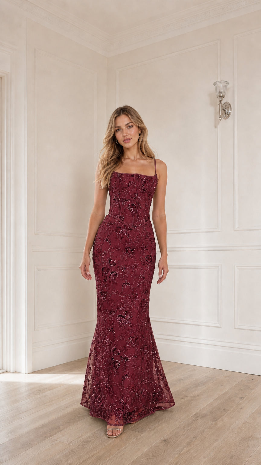 Woman wearing burgundy sequin embroidered corset maxi dress