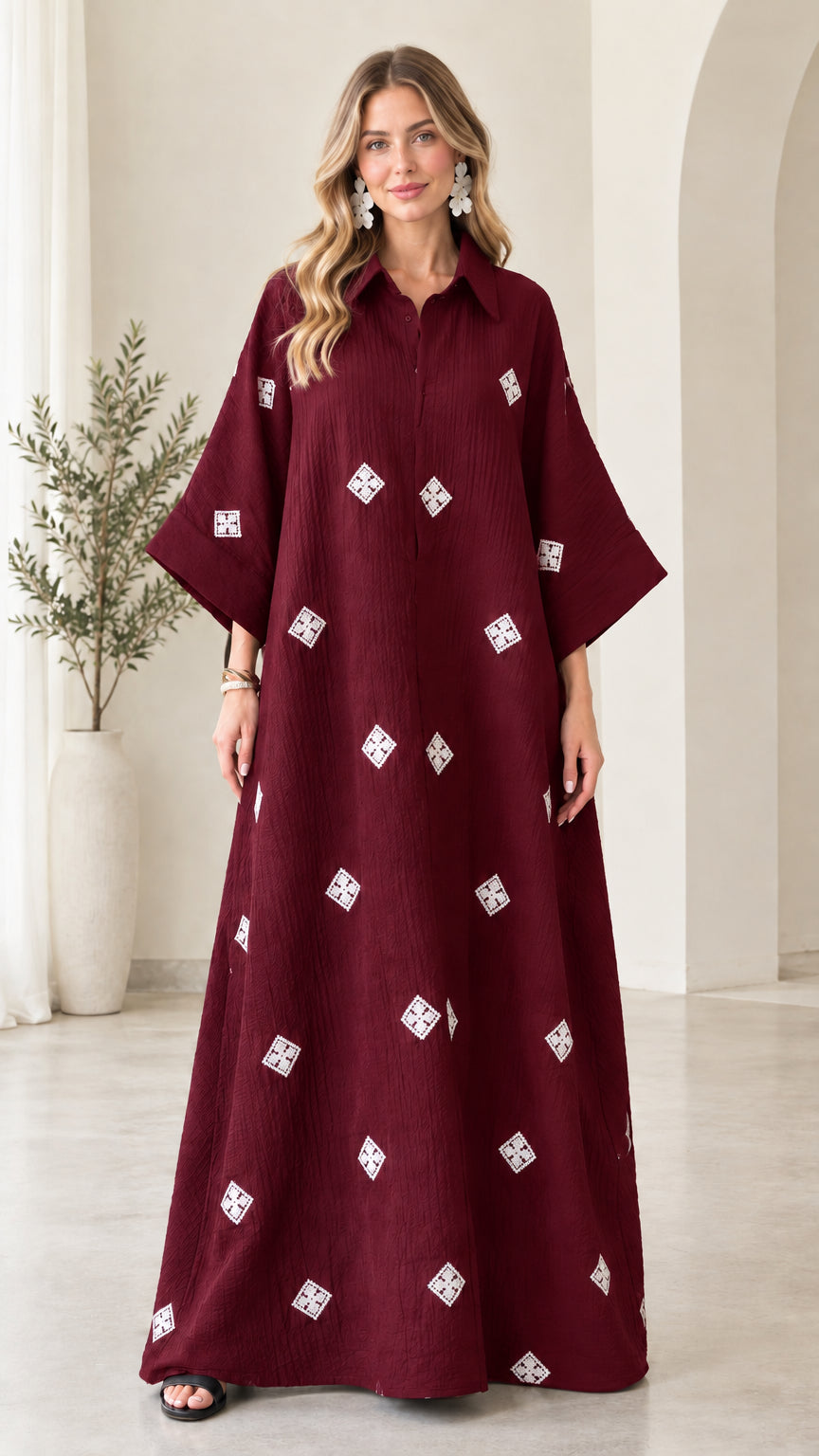 Front view of model wearing burgundy red embroidered crinkle maxi shirt dress