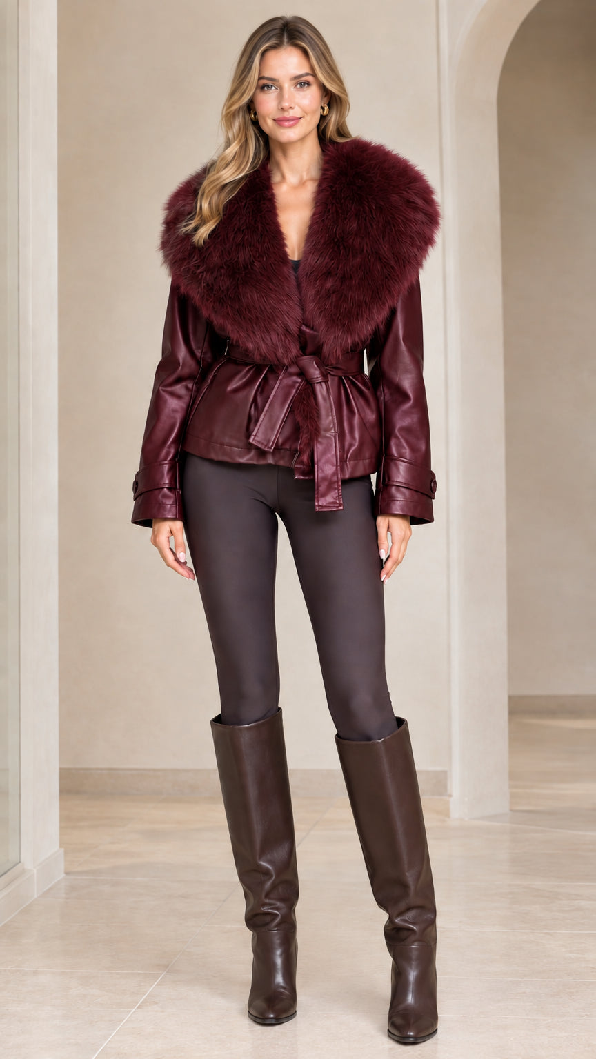 Front view of model wearing rich burgundy faux leather jacket with matching wine fur collar