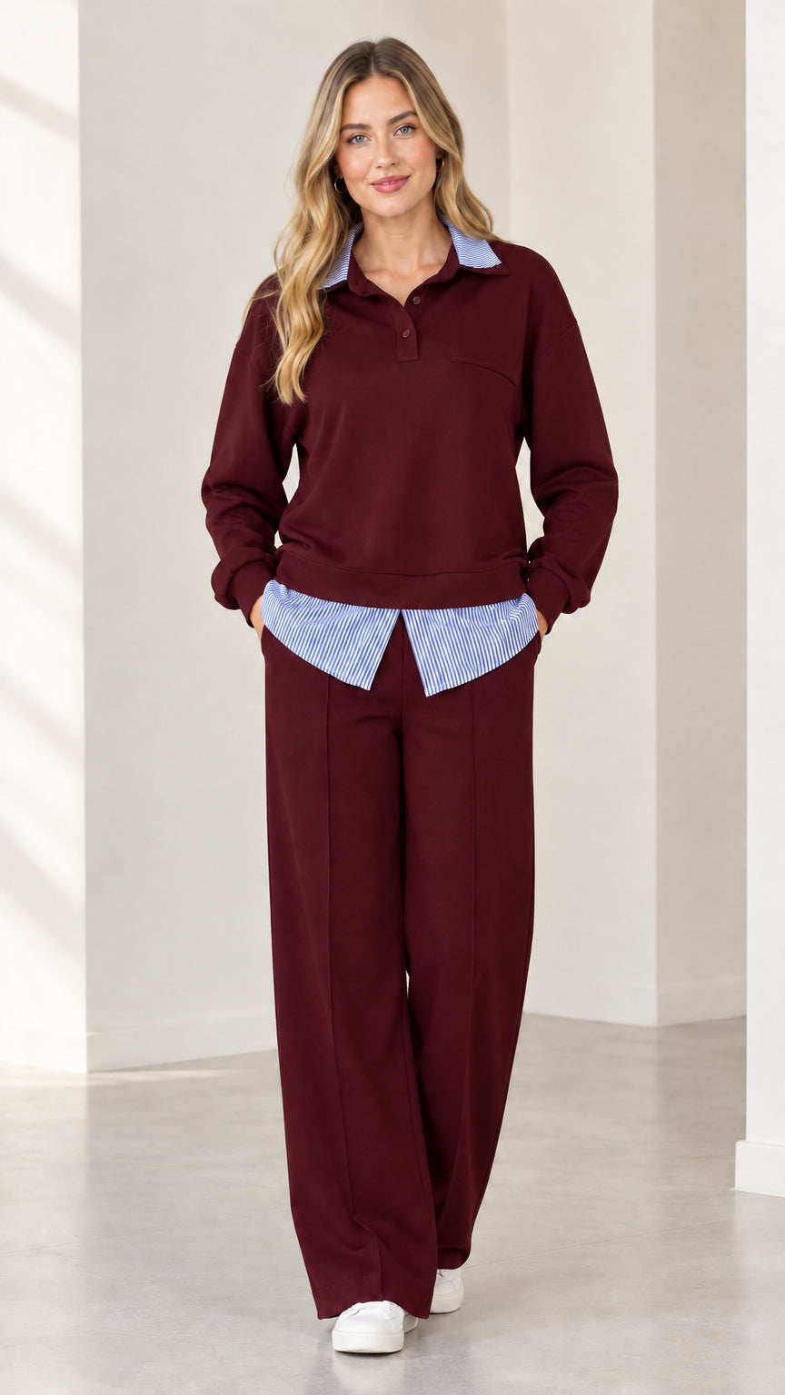 Full-body view of woman wearing burgundy red 2-piece layered lounge set