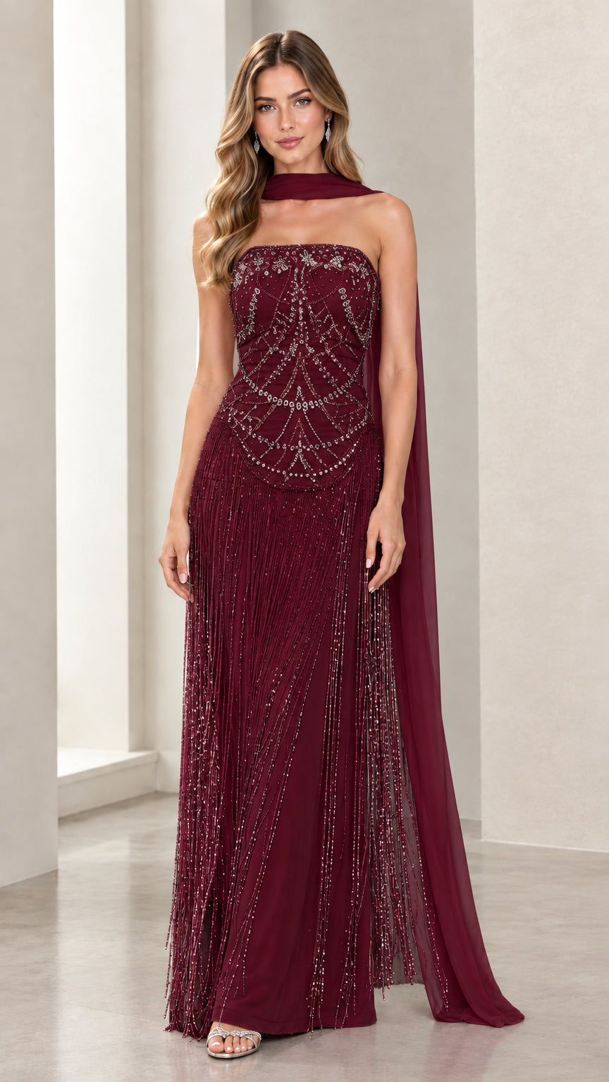 Front view of model wearing Burgundy wine strapless beaded fringe evening gown with matching scarf cape