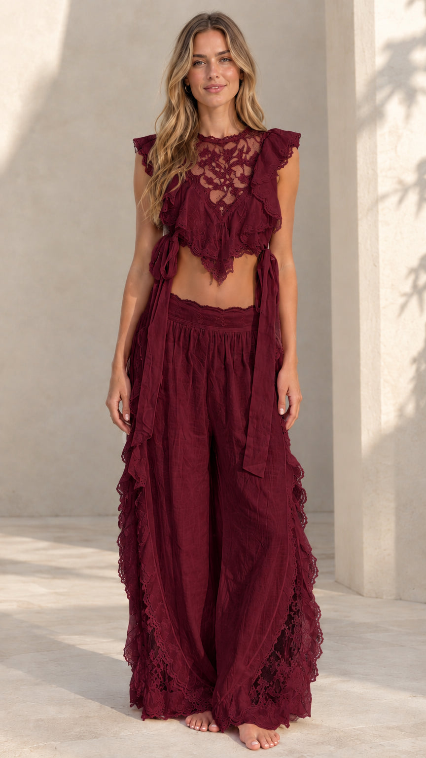 Woman wearing burgundy wine lace ruffle crop top and matching wide-leg palazzo pants
