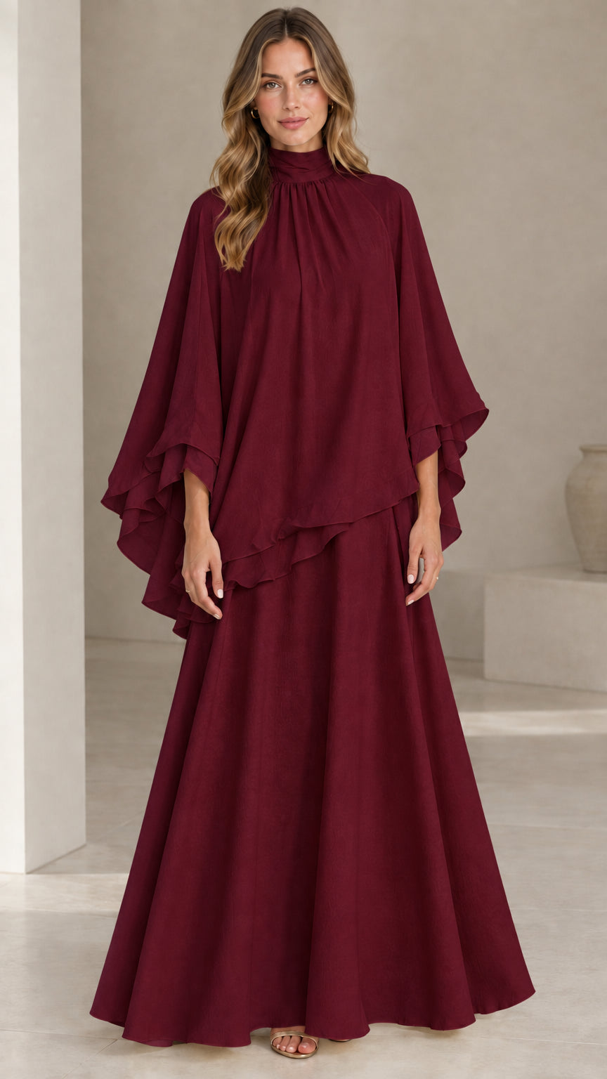 Front full-length view of model wearing burgundy wine high neck capelet maxi dress set