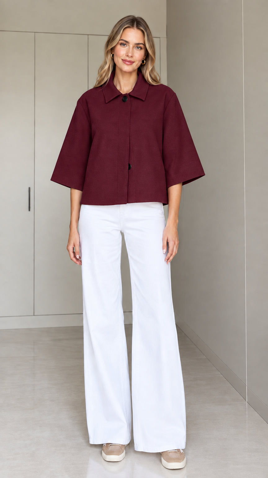 Front view of a woman wearing the cropped half-sleeve swing jacket in burgundy