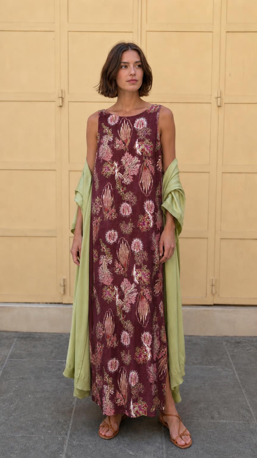 Model wearing burgundy floral print sleeveless maxi dress with matching wrap