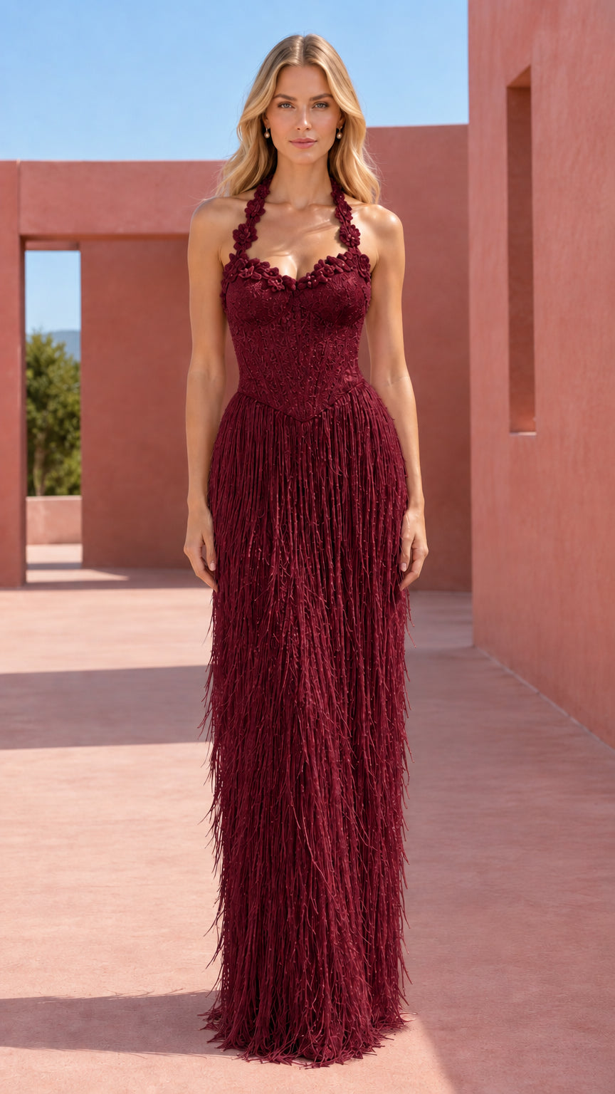 Model wearing burgundy red halter corset fringe maxi evening dress