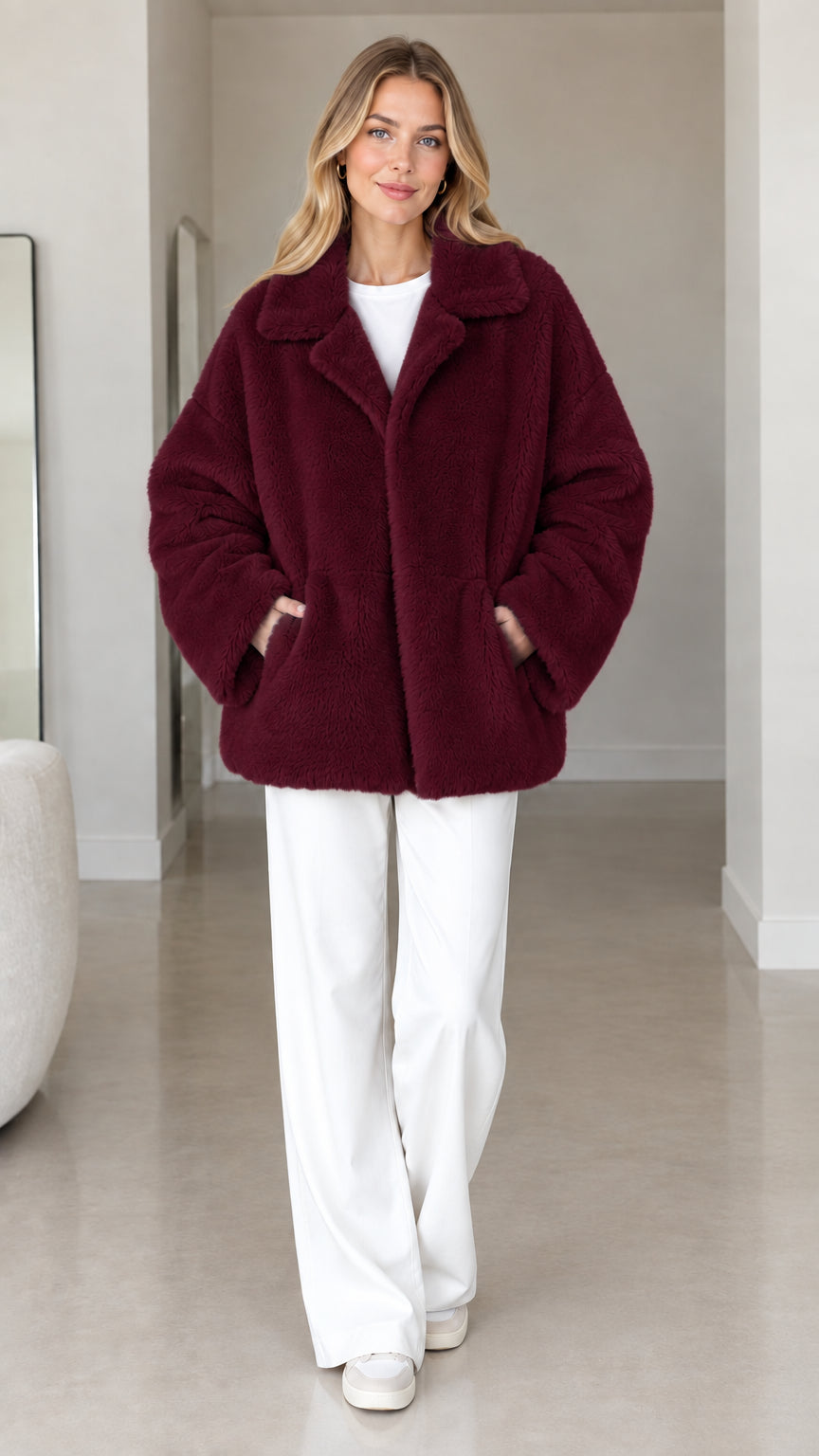 Front view of model wearing burgundy plush faux fur lapel coat