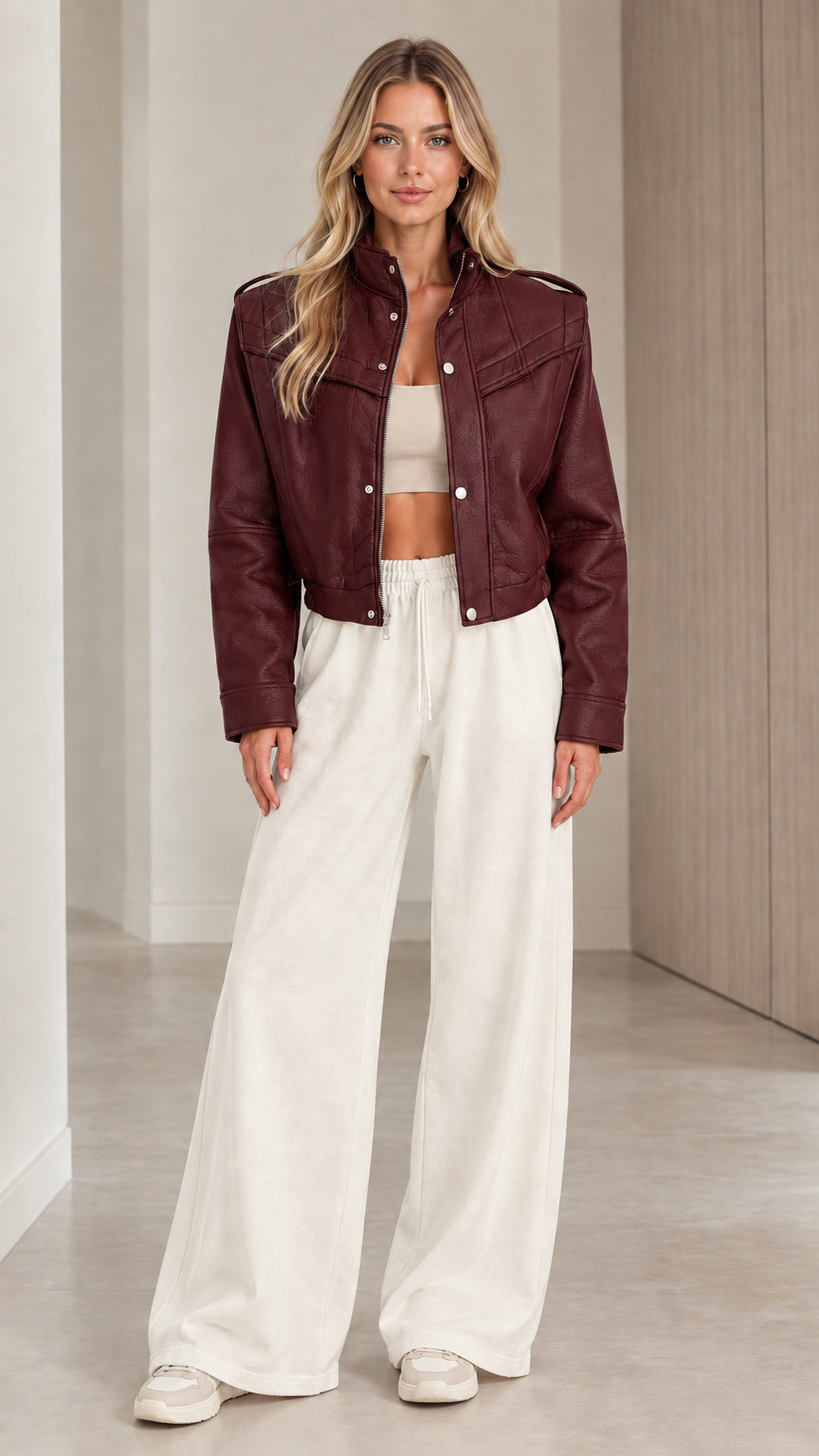 Front full view of woman wearing the cropped faux leather jacket in Burgundy