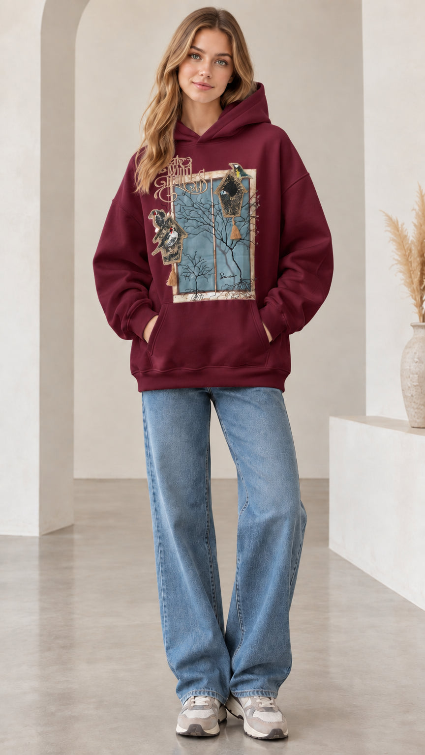 Front view of woman wearing burgundy wine vintage nature bird graphic hoodie