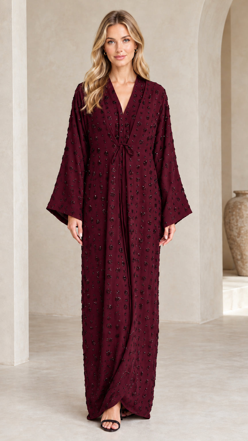 Front view of woman wearing Burgundy wine-toned embellished formal maxi dress