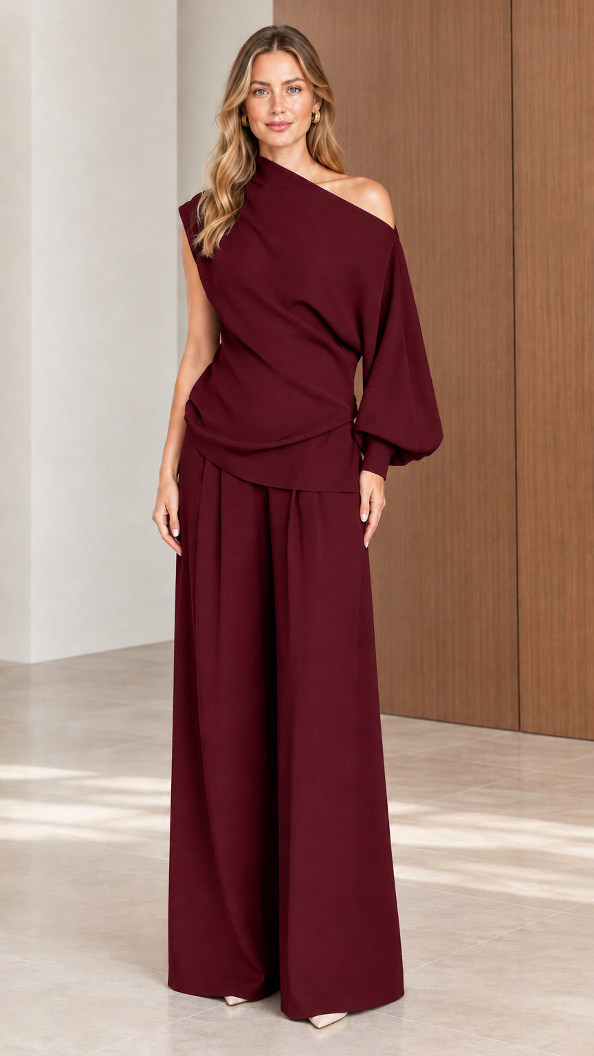 Front view of model wearing Burgundy wine one-shoulder draped two-piece pant set