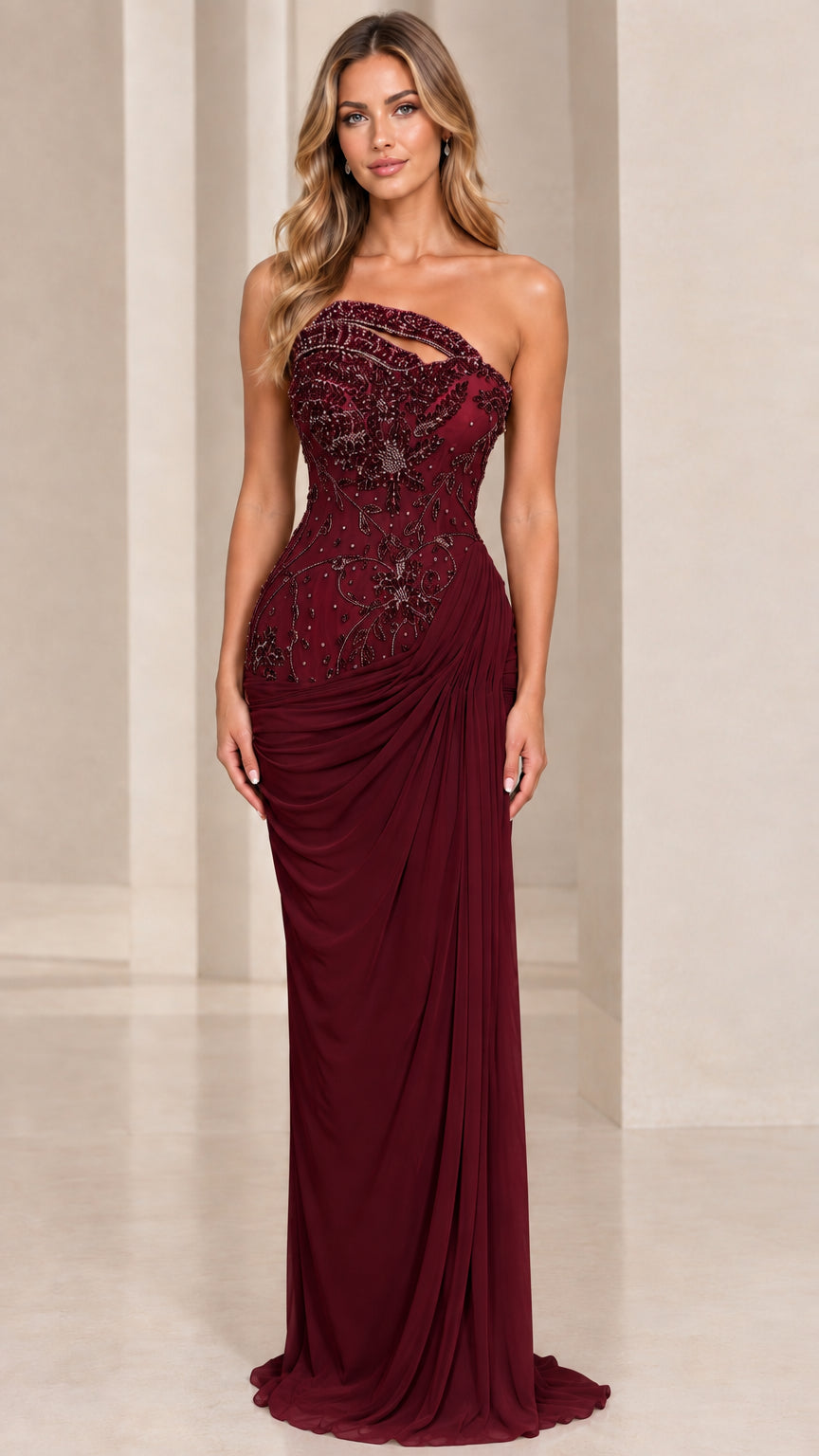 Front view of model wearing burgundy wine asymmetrical beaded evening gown